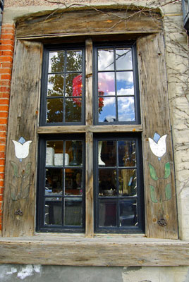 a quaint window with painted tulips