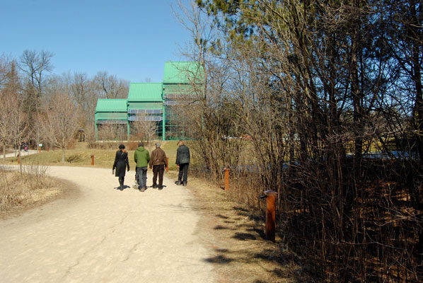 visitors walk towards the main buildings at the Kortright Centre of Conservation
