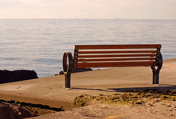 a bench on the pier offers a view of Lake Ontario