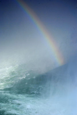 a rainbow glows at the base of Niagara Falls