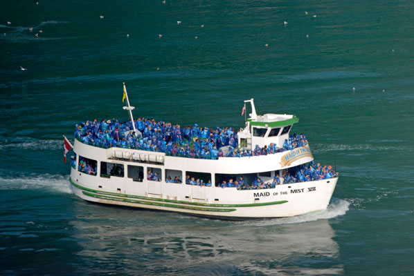 blue raincoats can be seen on the upper and lower decks of the Maid of the Mist